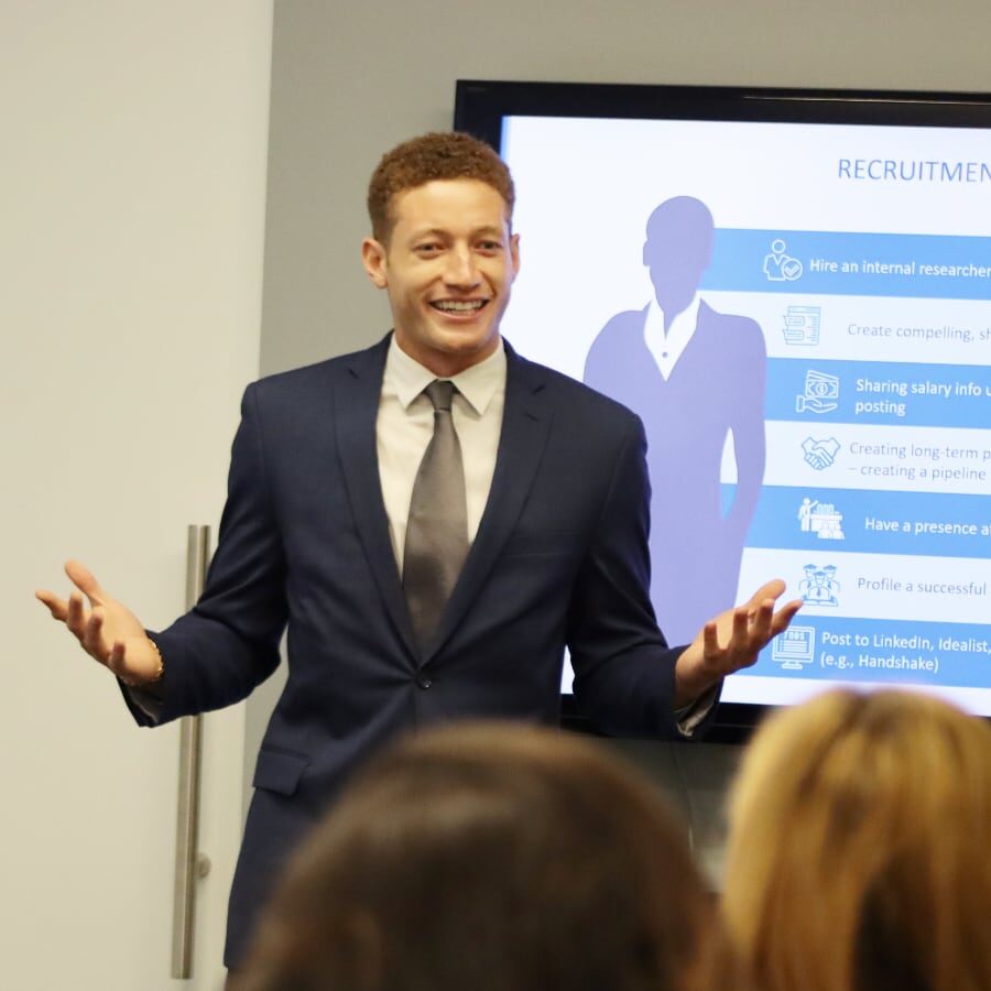 Man presenting to colleagues during a meeting